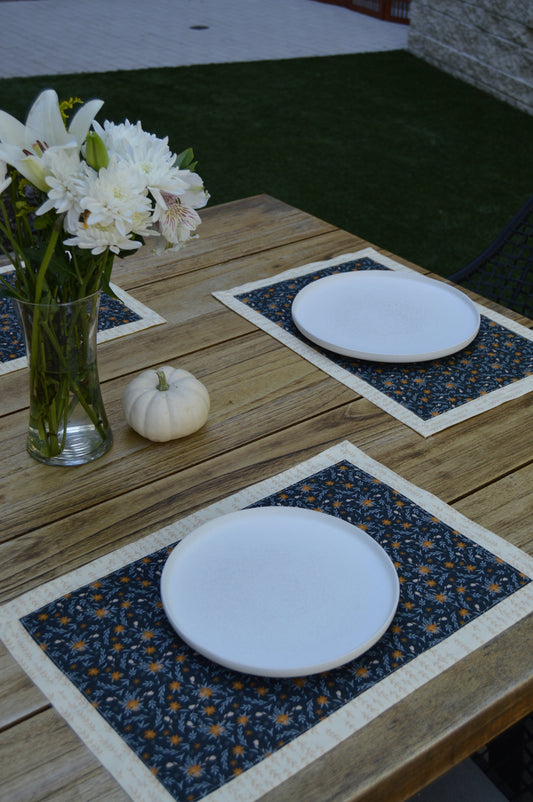 picnic table setting with 2 navy floral fall placemats and plates